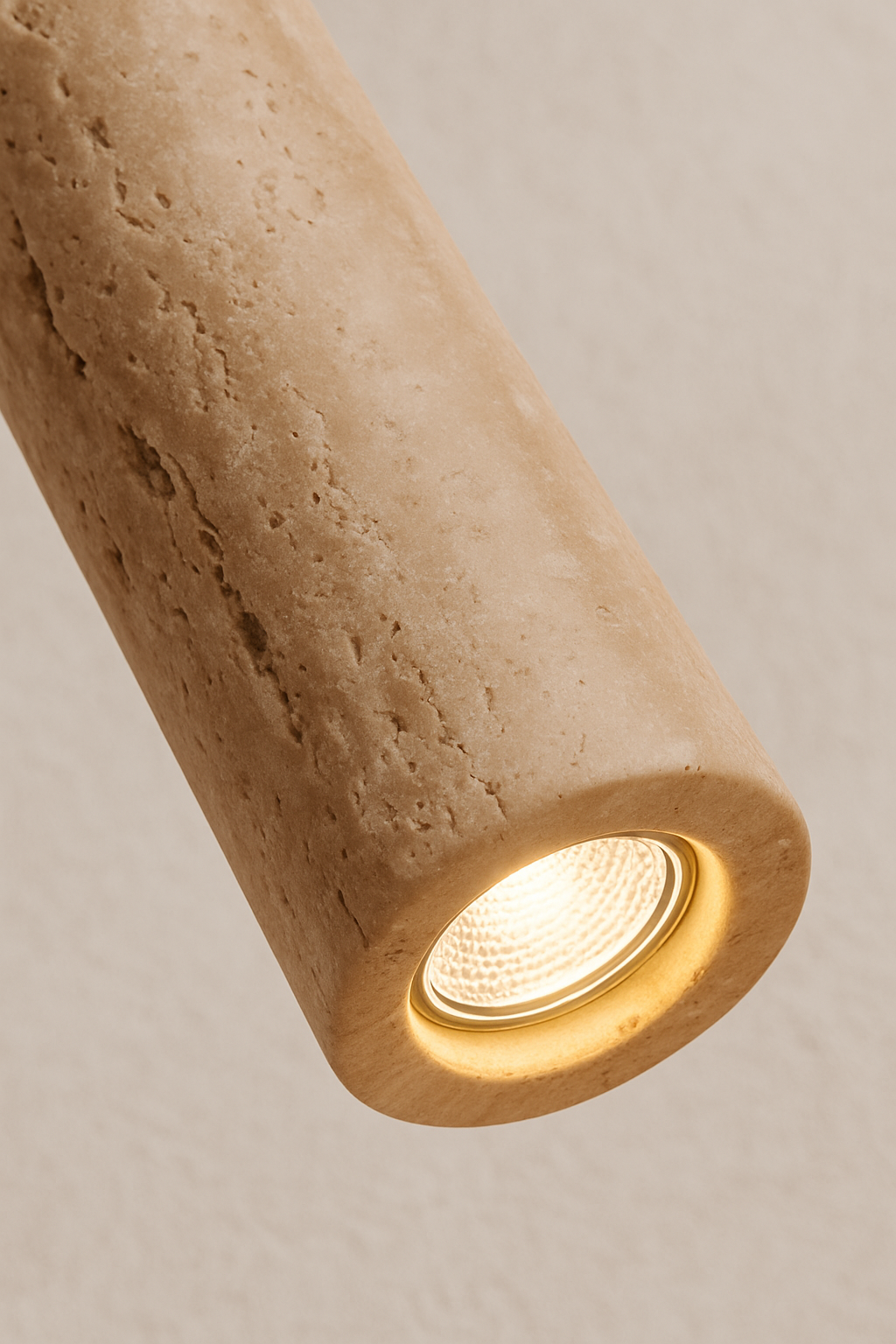 Cylindrical stone light fixture on a neutral background